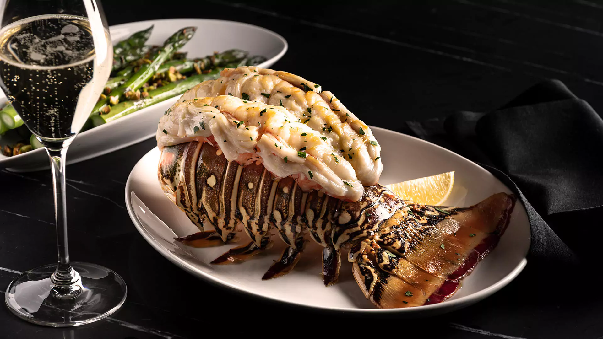 Decadent Lobster Tail with a Glass of Wine at DelFrisco’s