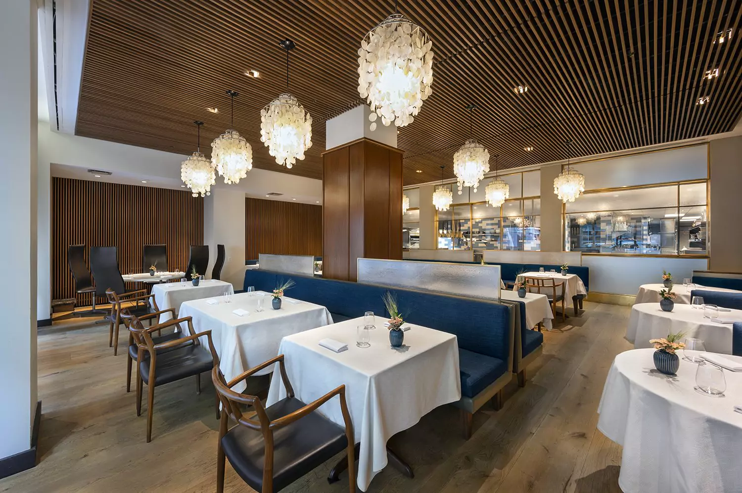 Modern and Luxury Dining Area in Aquavit with Scandinavian Furniture and Splashes of Blue