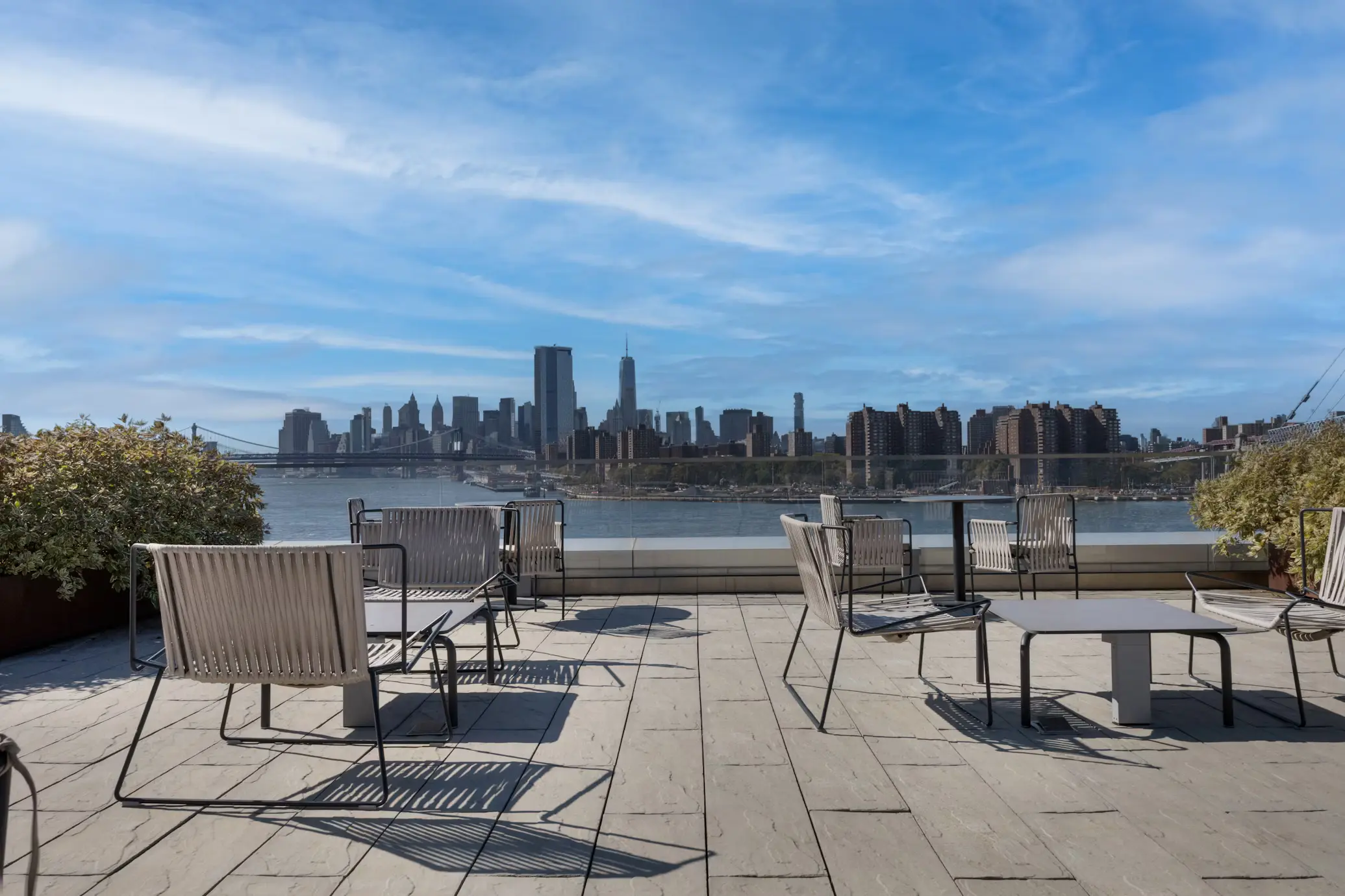 Rooftop Terrace with Modern Seating and Views of the Waterfront, Bridge, and NYC Skyline